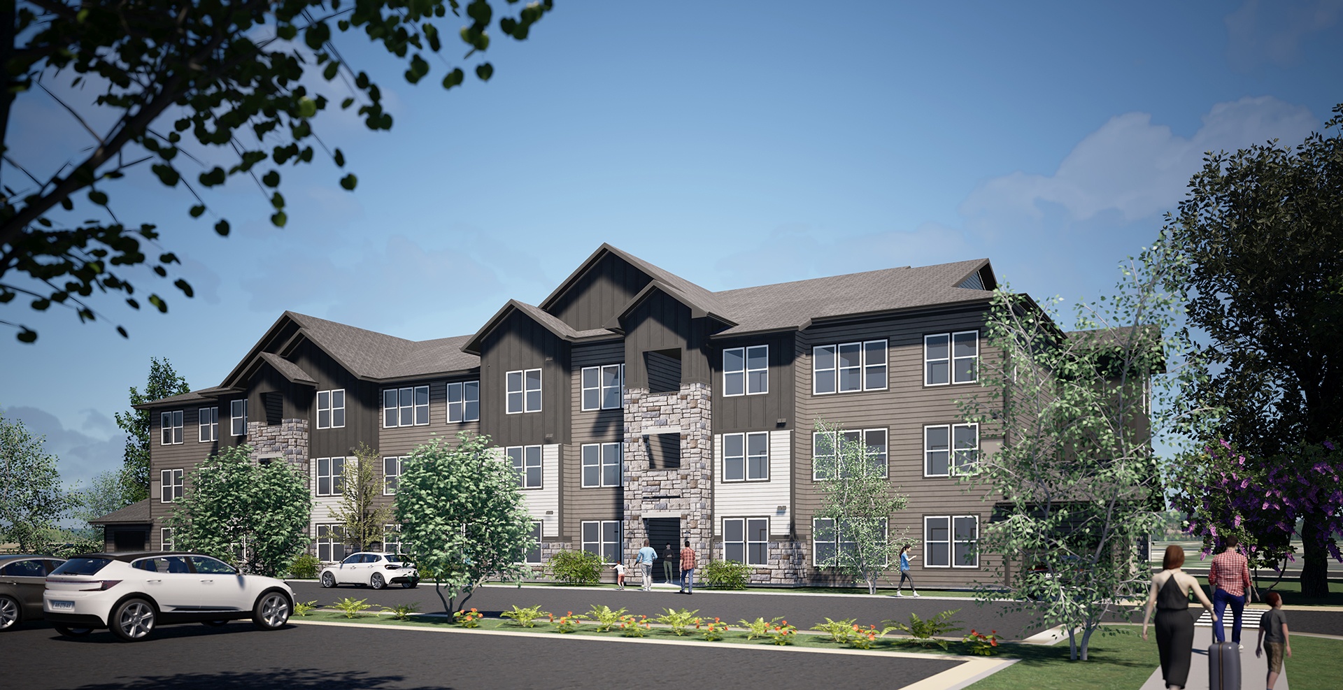 A modern apartment complex with a parking lot in front.